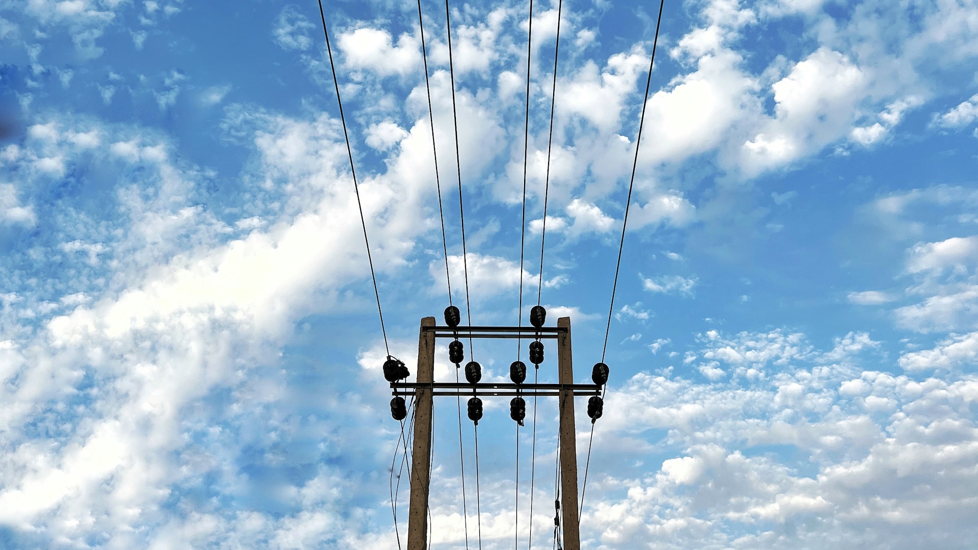 power lines with blue sky and clouds