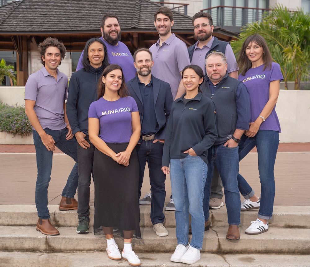 Group photo of the Sunairio team in branded purple T shirts